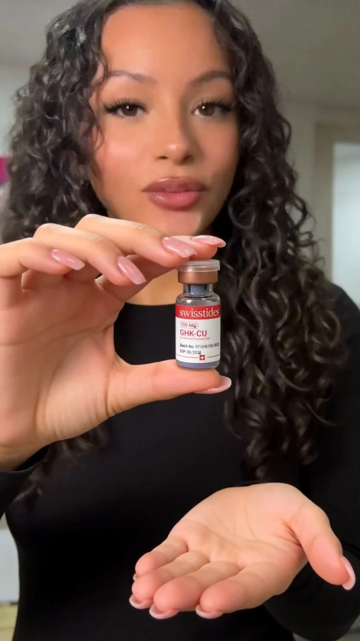 A customer holding her Swiss Tides GHK-Cu vial up to the camera
